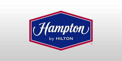 Hampton by Hilton with Official Airport Parking with Official Airport Meet and Greet logo