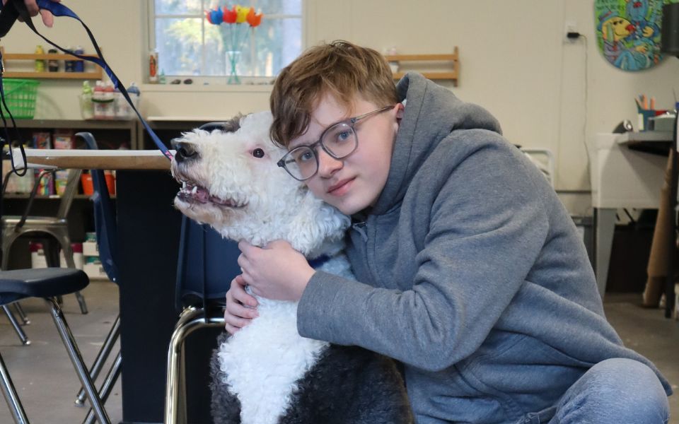 boy hugging dog