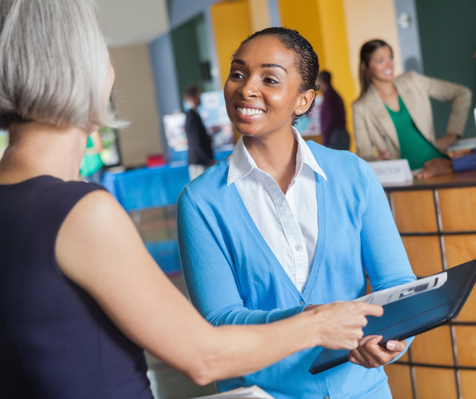 woman smiling holding folder