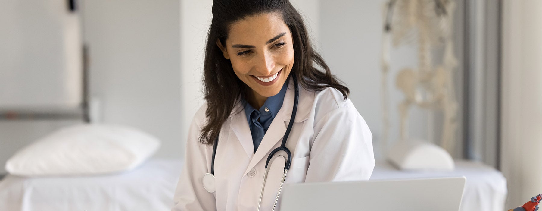 Doctor watching CME on laptop
