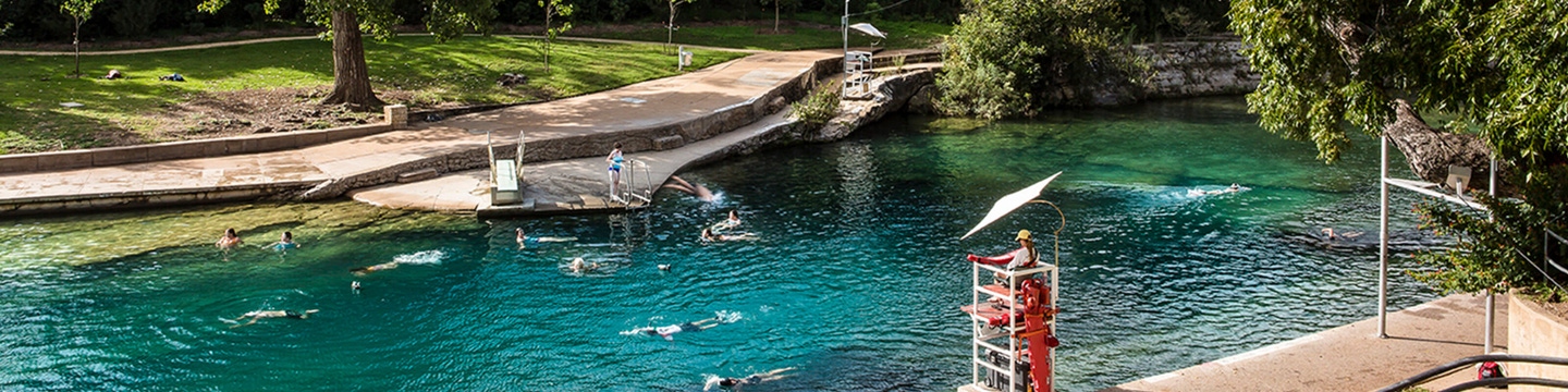People swimming at the Barton Springs Pool