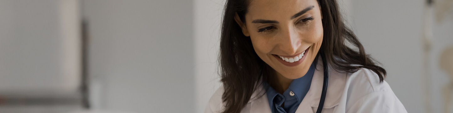 Healthcare worker with a laptop at their desk