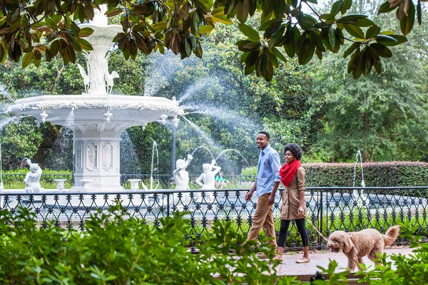 Couple Walking Dog in Forsyth Park in Savannah, Georgia