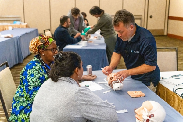 Instructor with students at suturing workshop