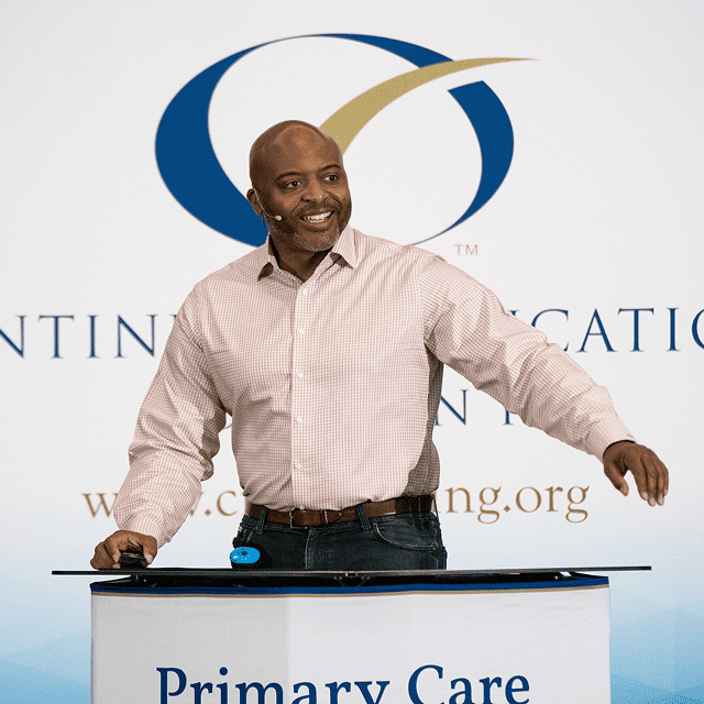 Dr. Hicks speaking at conference.