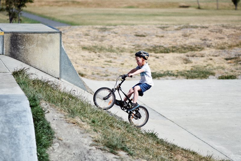 kid in park going uphill on bicycle