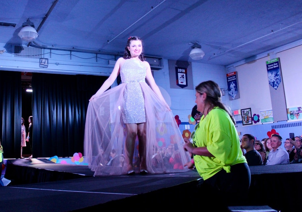 Student Ionna Saviolidis models a dress from Le Château down the catwalk at the “Welcome to the 60s” fashion show at Summit School on April 25.