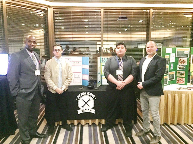 two student and two teachers standing