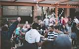 Photograph from Samantha Gades of people celebrating under christmas lights in an atrium