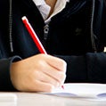 kid writing with a pencil on paper icon