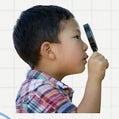 child with magnifier