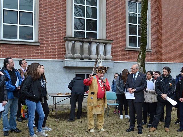 first nation elder man speaking with students