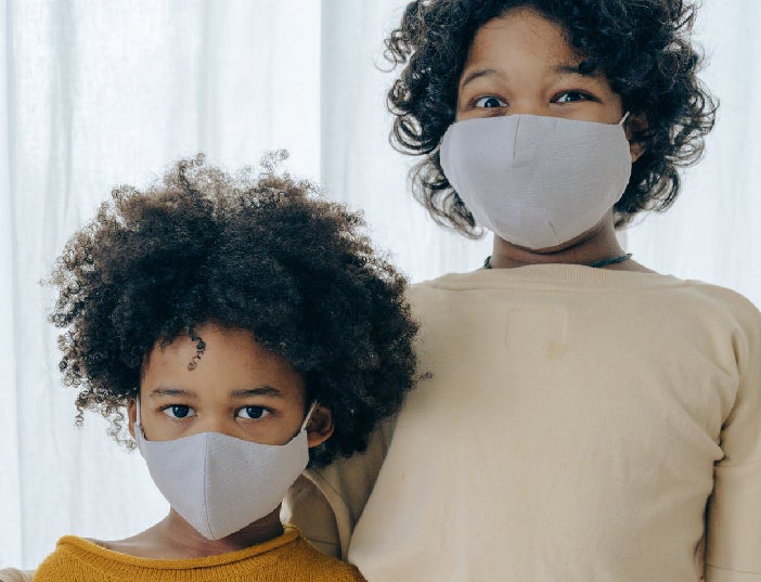 Siblings with face coverings