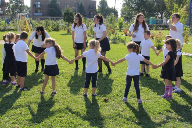 Students holding hands outside