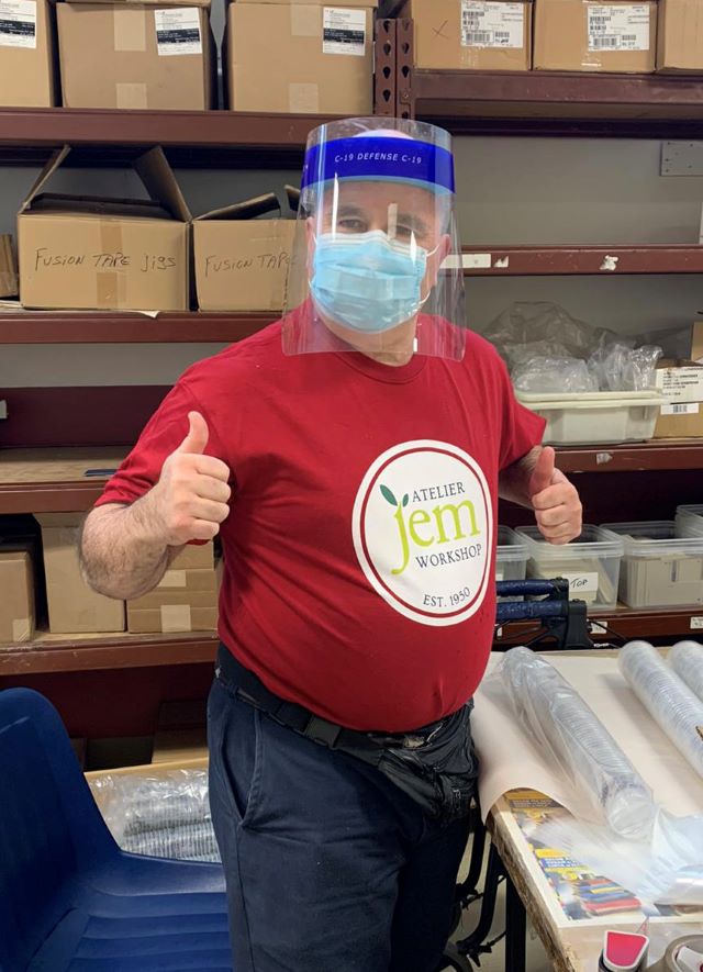 JEM Worker Daniel Dubuc proudly shows off his new T-shirt printed by Promo 21.