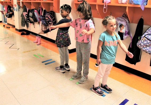 Photo: Children at St. Jude School play in the sensory-motor pathway, practising different movements. Photo courtesy of the Riverside School Board