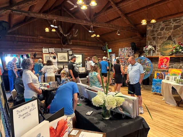 Attendees admire the art donated by Dunany Studio Artists. Photo courtesy of Jaime Bisaillon