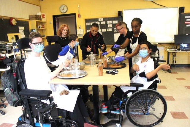 Leaders on Wheels bottle their spice rub with special visitor Simon Chang in their classroom at Westmount High on October 10. Photos: Wendy Singer