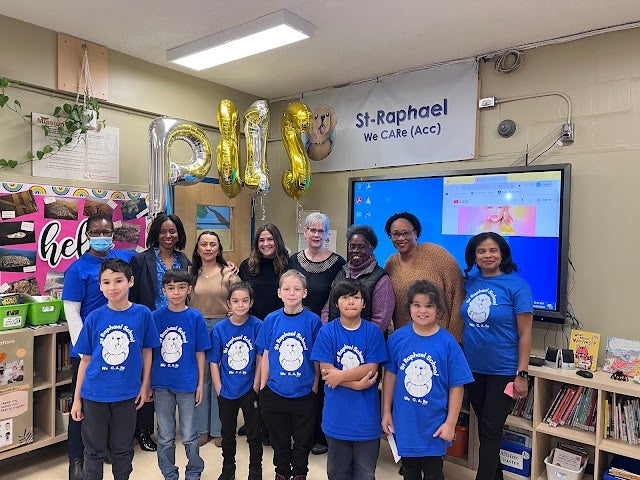 At St. Raphael Elementary School on November 29, 2023, from left, back row: Dr. Léna Moïse, school psychologist; Gail Callender, assistant director of Student Services; Jackie Alvarado and Cindy Mendez, both behaviour management specialists; Michelle Aubin, former educational consultant; Kathy Roach, community worker; Jasmin Skerritt, behaviour management specialist; and principal Joe Anne Désir. Front row: Grade 4 students. Photo courtesy of St. Raphael Elementary School