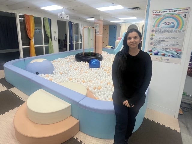Niri Azuaje stands in front of a ball “pool,” one of seven rooms that makes up Sensetional.