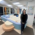 Niri Azuaje stands in front of a ball “pool,” one of seven rooms that makes up Sensetional. 