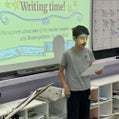 Student Olivia Munro stands at the front of the class reading her poem during the poetry workshop