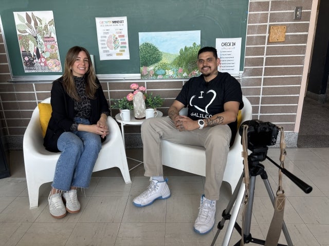 Teacher Marilyn Damato interviewing student Ivan Rivars-Sanamaria. They are both seated looking towards the camear