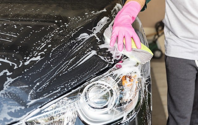 young man washing a car