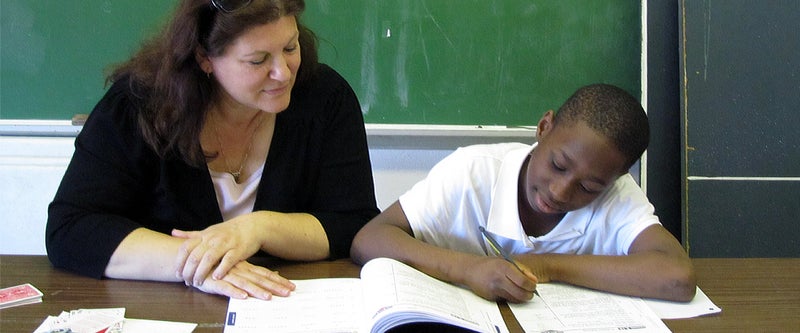 Teacher supporting a student