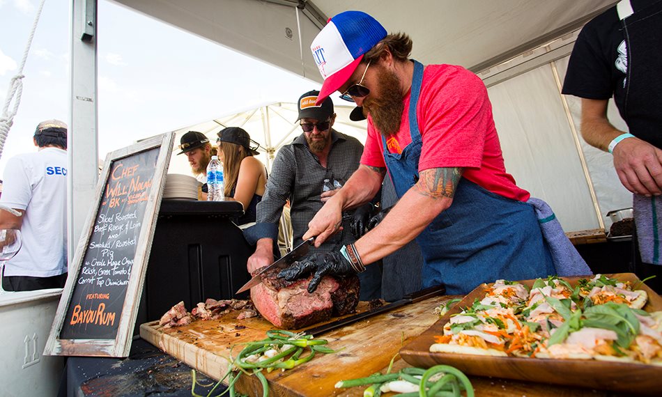 man cutting beef at festival