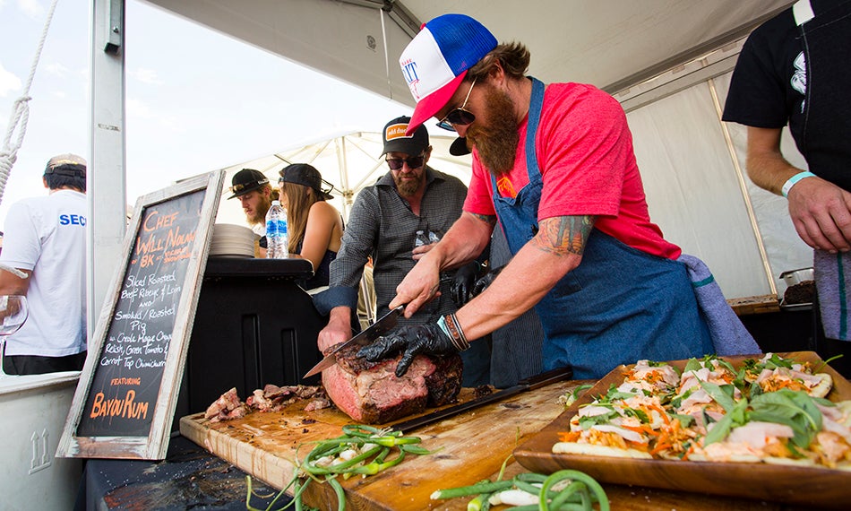 man cutting beef at festival