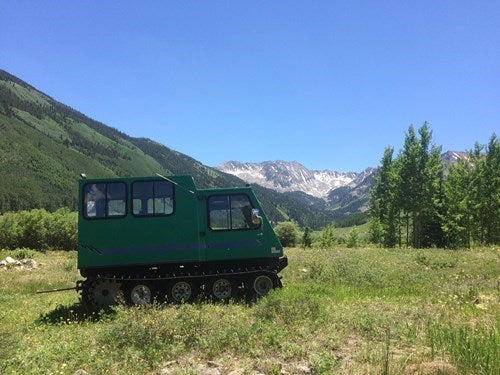 tractor in front of mountains