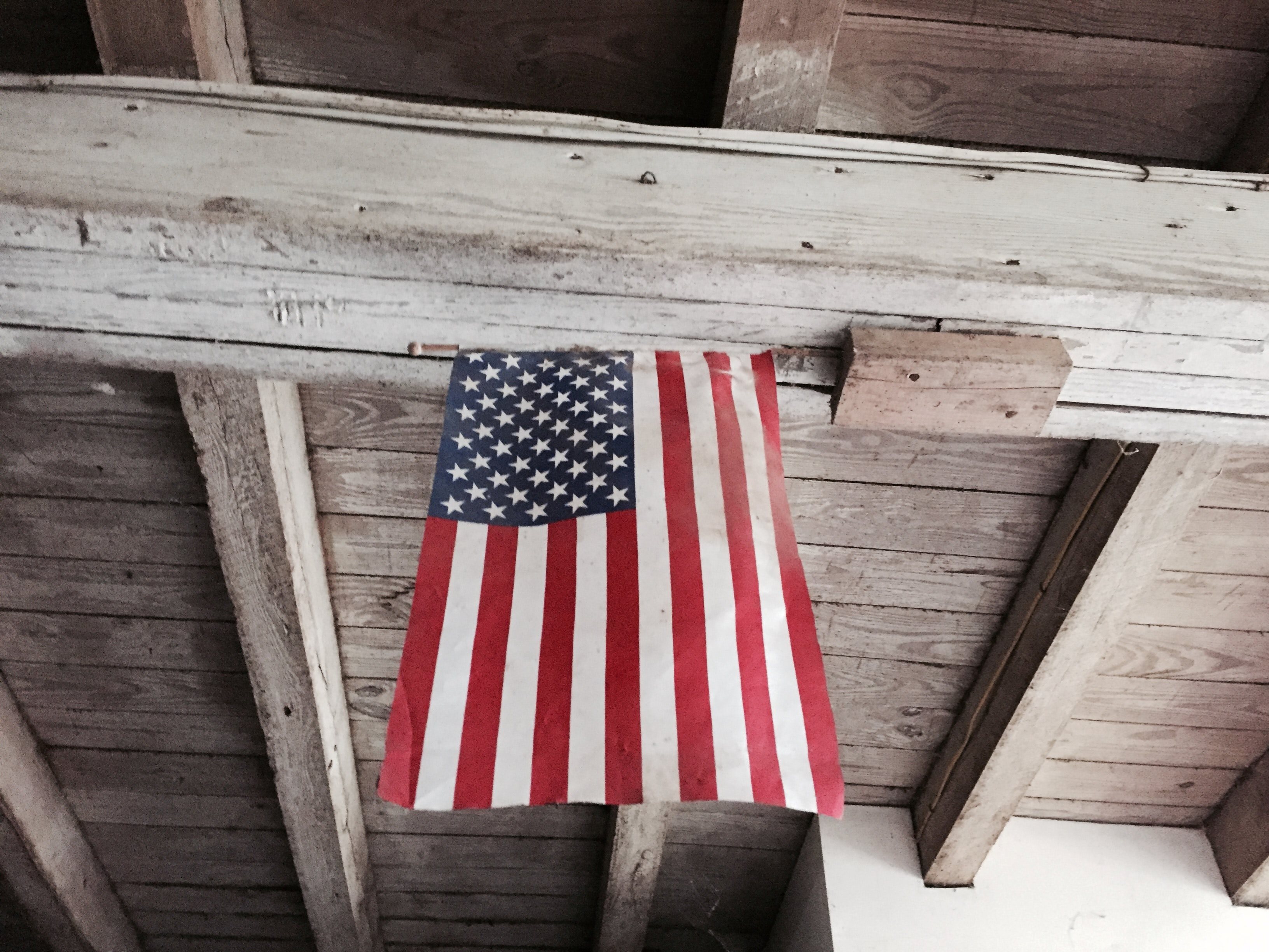 flag hanging from barn on labor day