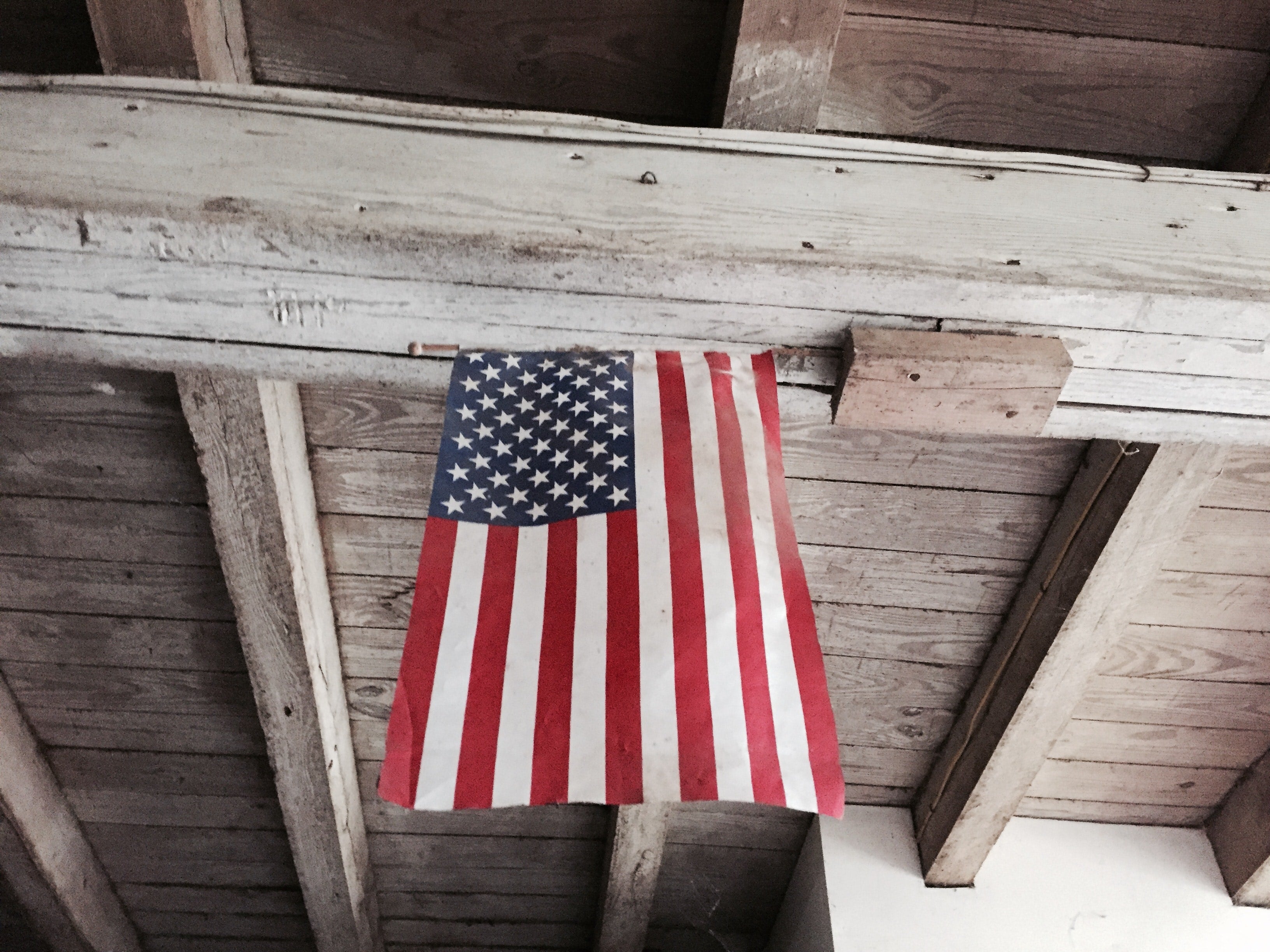 flag hanging from barn on labor day