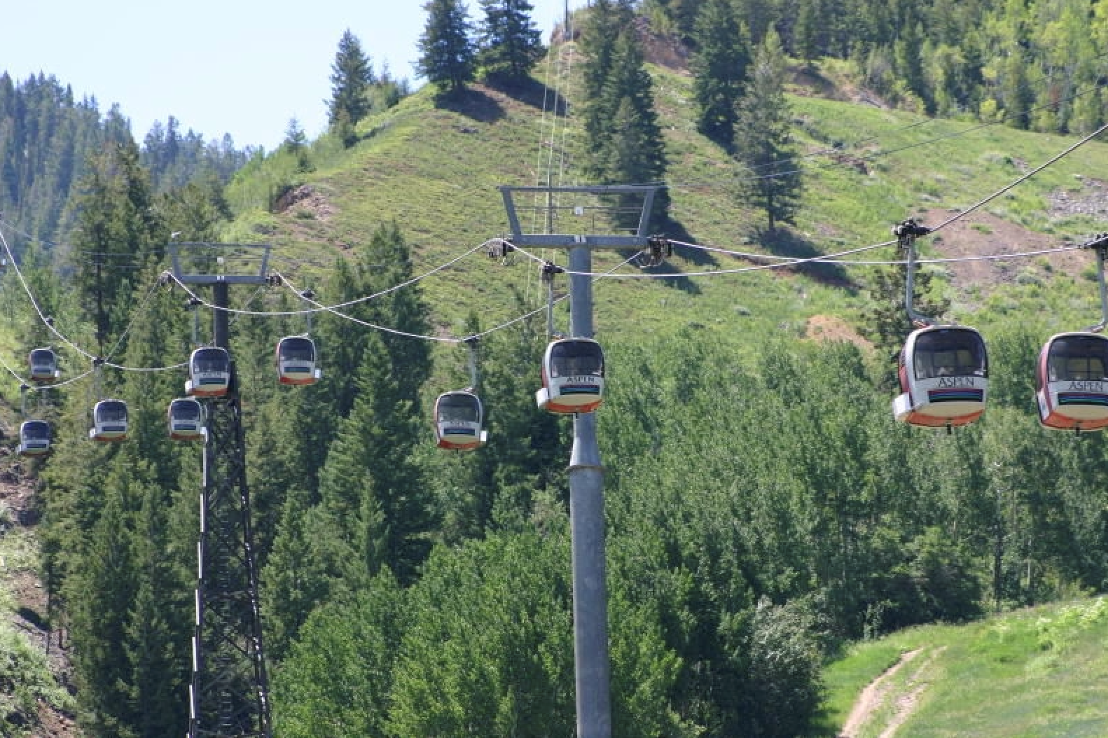 gondolas moving up mountain side