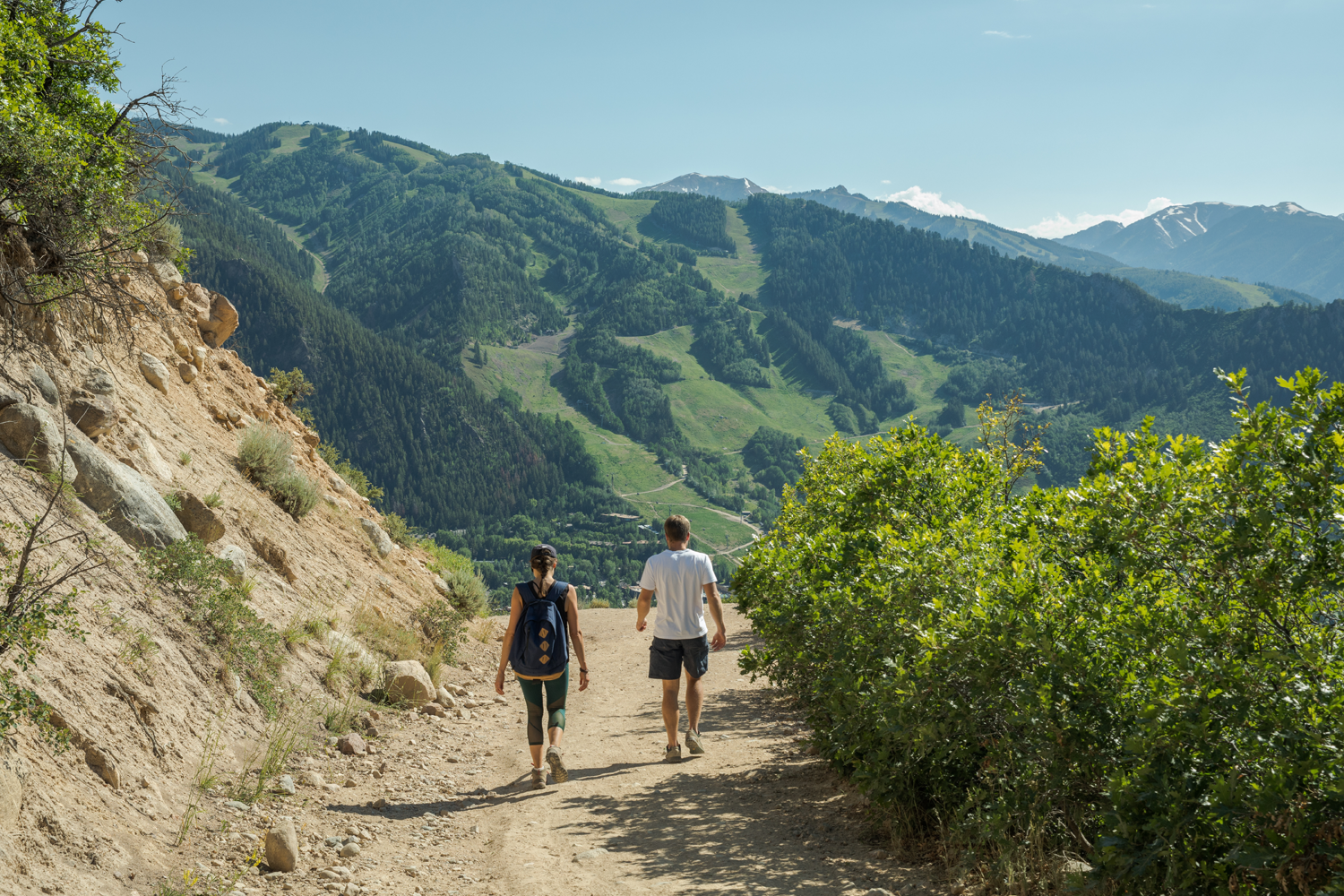 couple hiking in front of mountain